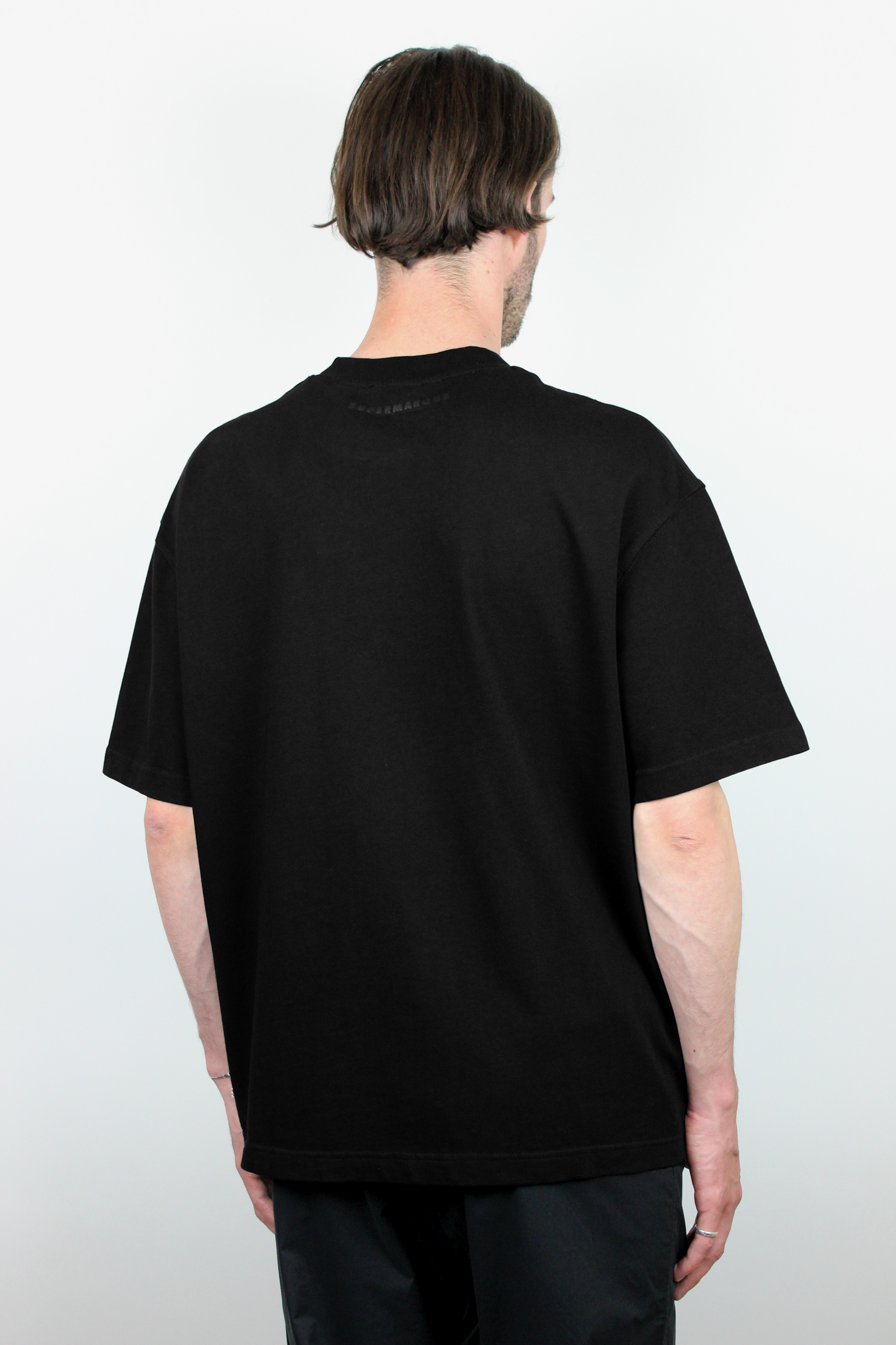 Person wearing a black t-shirt on a white background