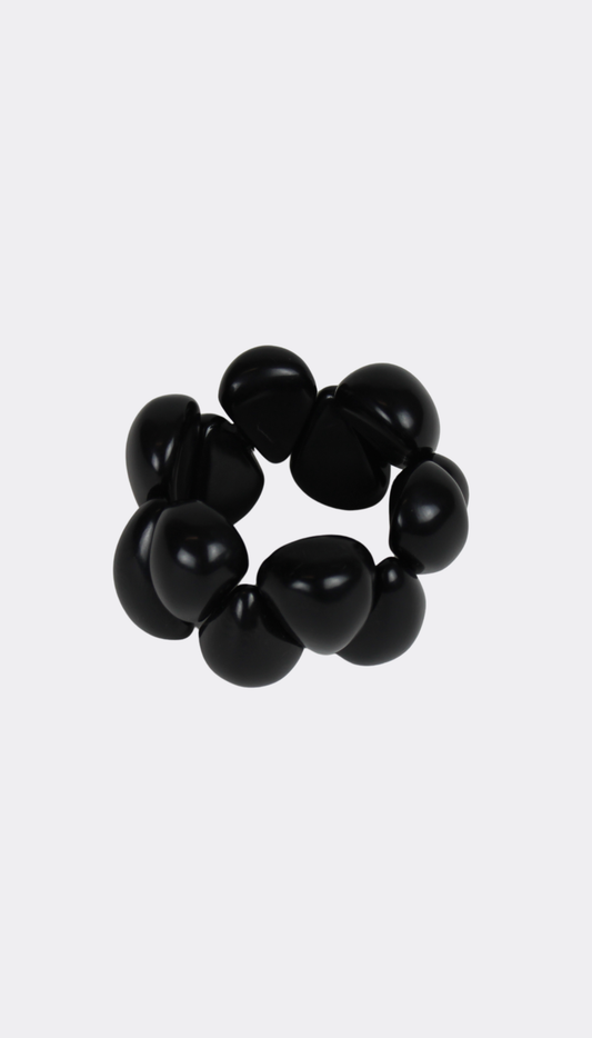 Black tagua bracelet on a white background