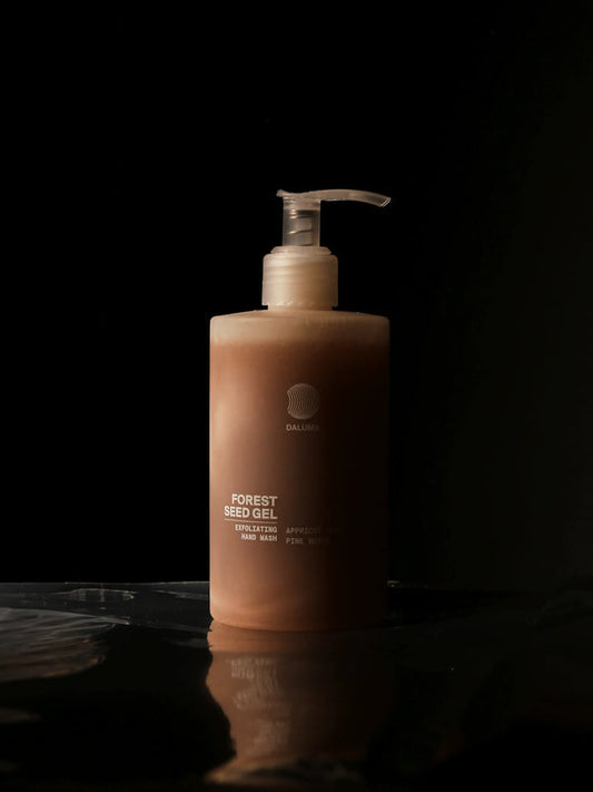 Bottle of Forest Seed Gel on a dark background