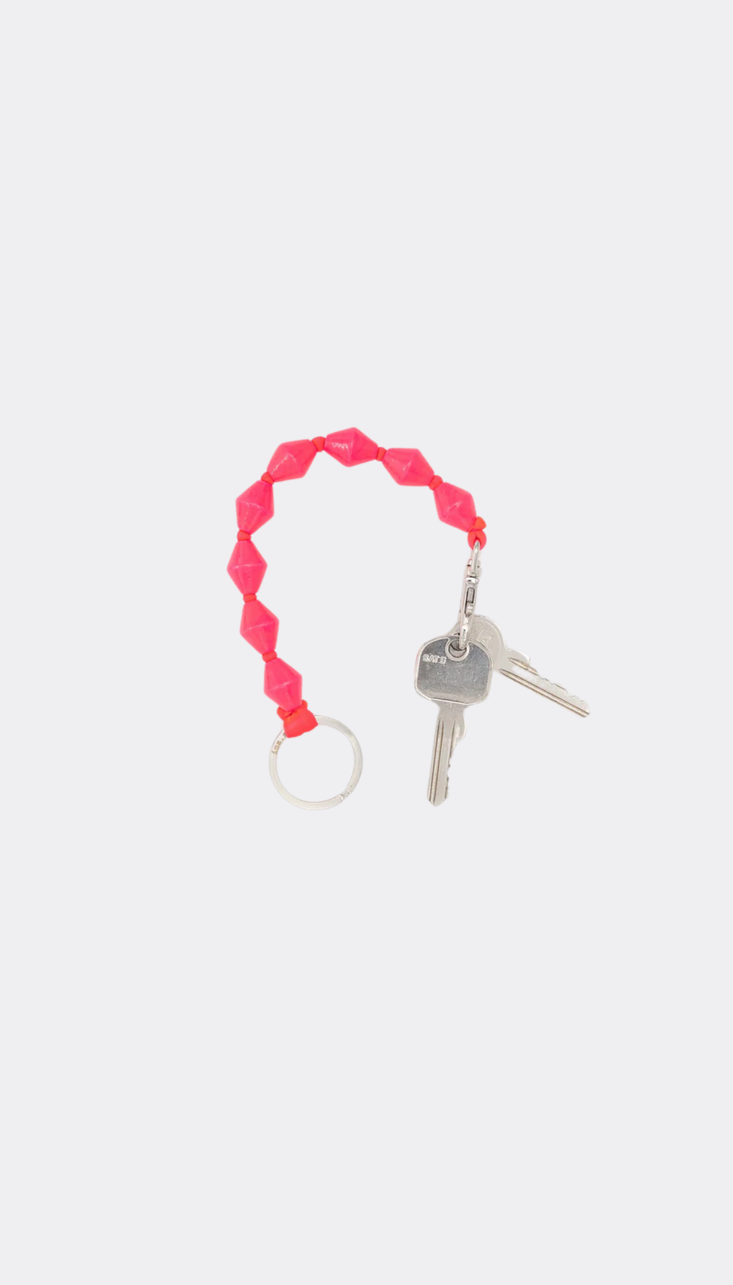 Pink keychain with keys on a white background