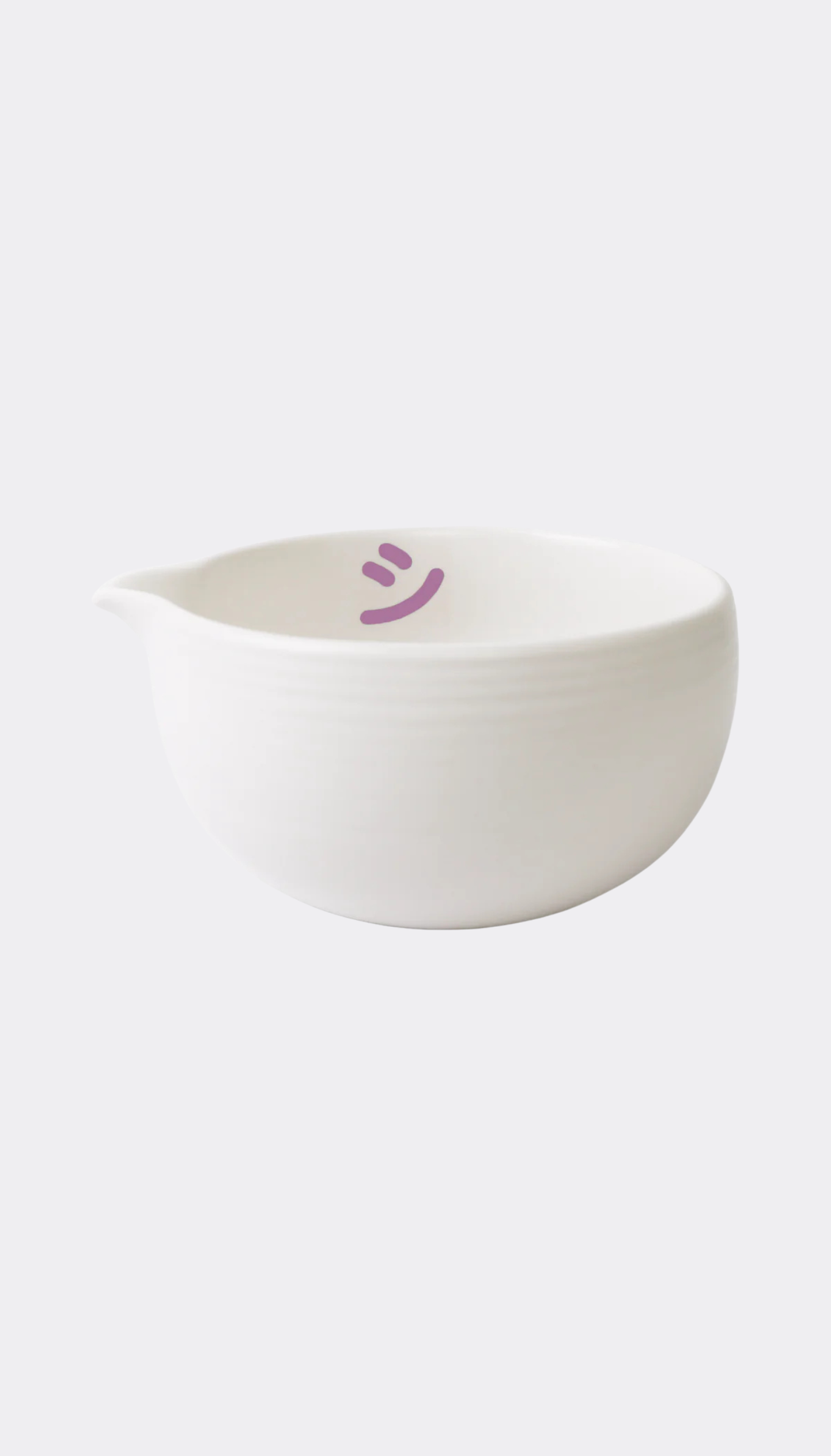 White ceramic bowl with a smiley face on a white background