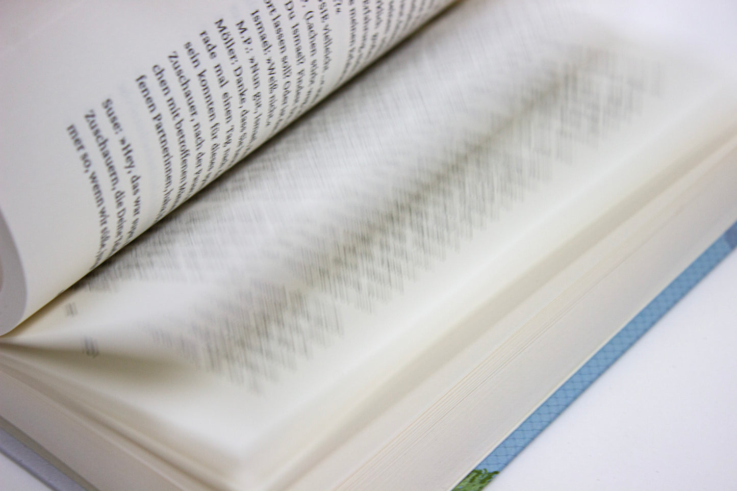 Close-up of an open book with text on a white background