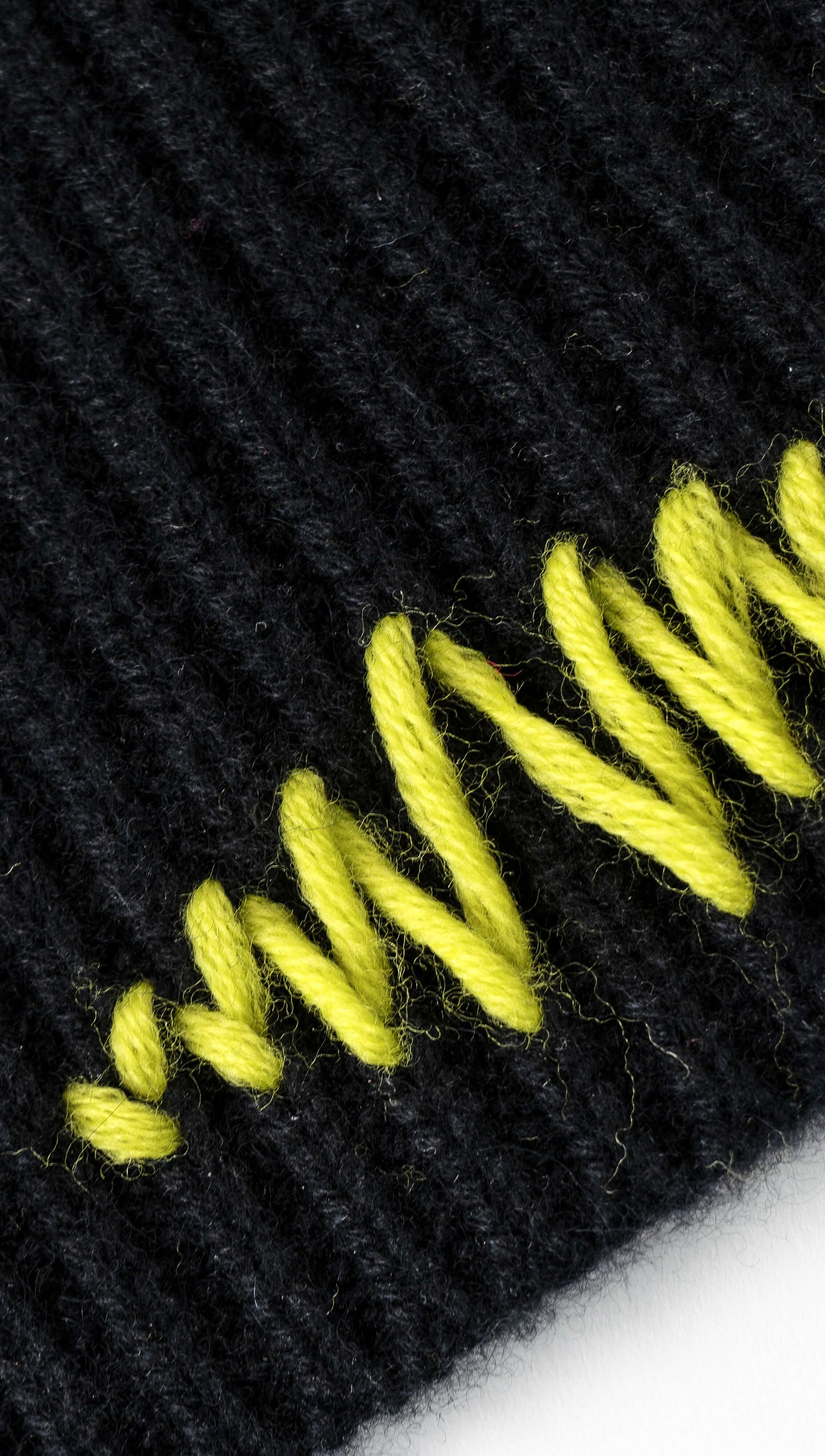 Yellow stitching detail on black beanie