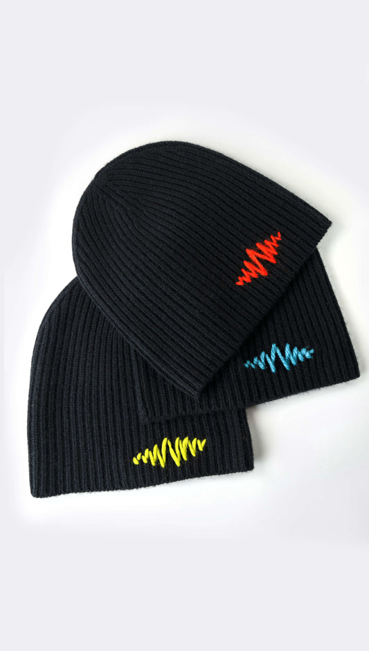 Three beanies with blue, yellow and red hand stitched SUPERMARQUE logo