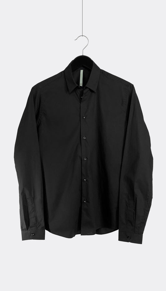 A black cotton poplin shirt with a point collar and buttoned cuffs, hanging against a white background.