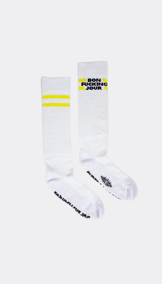 White socks with yellow stripes and black text "BON FUCKING JOUR" on a white background