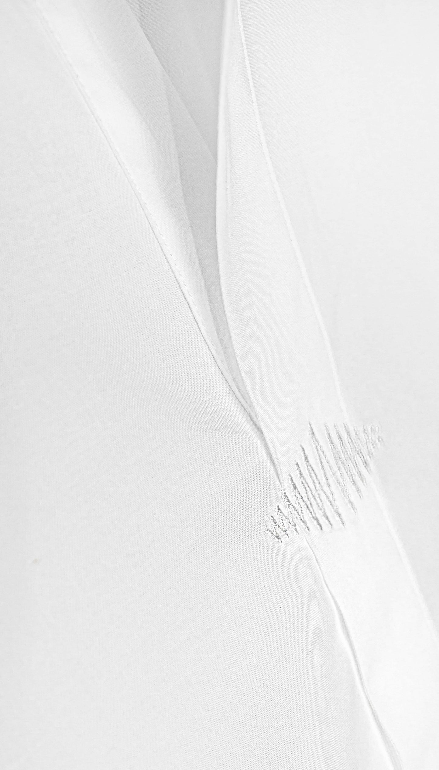 Close-up of a SUPERMARQUE logo stitched on shirt.