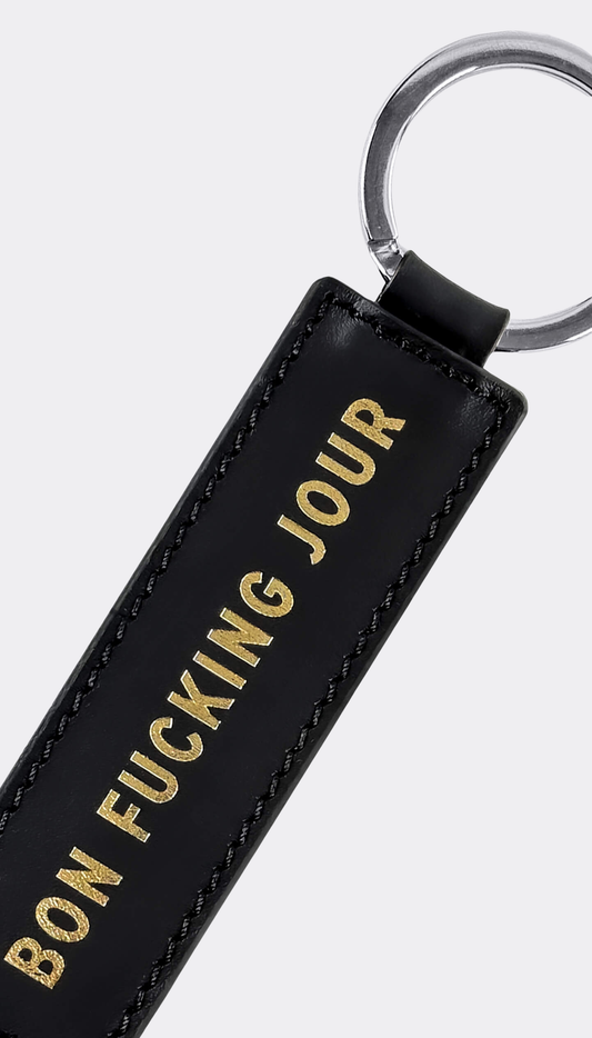 Detail of engraving Bon Fucking Jour on keychain