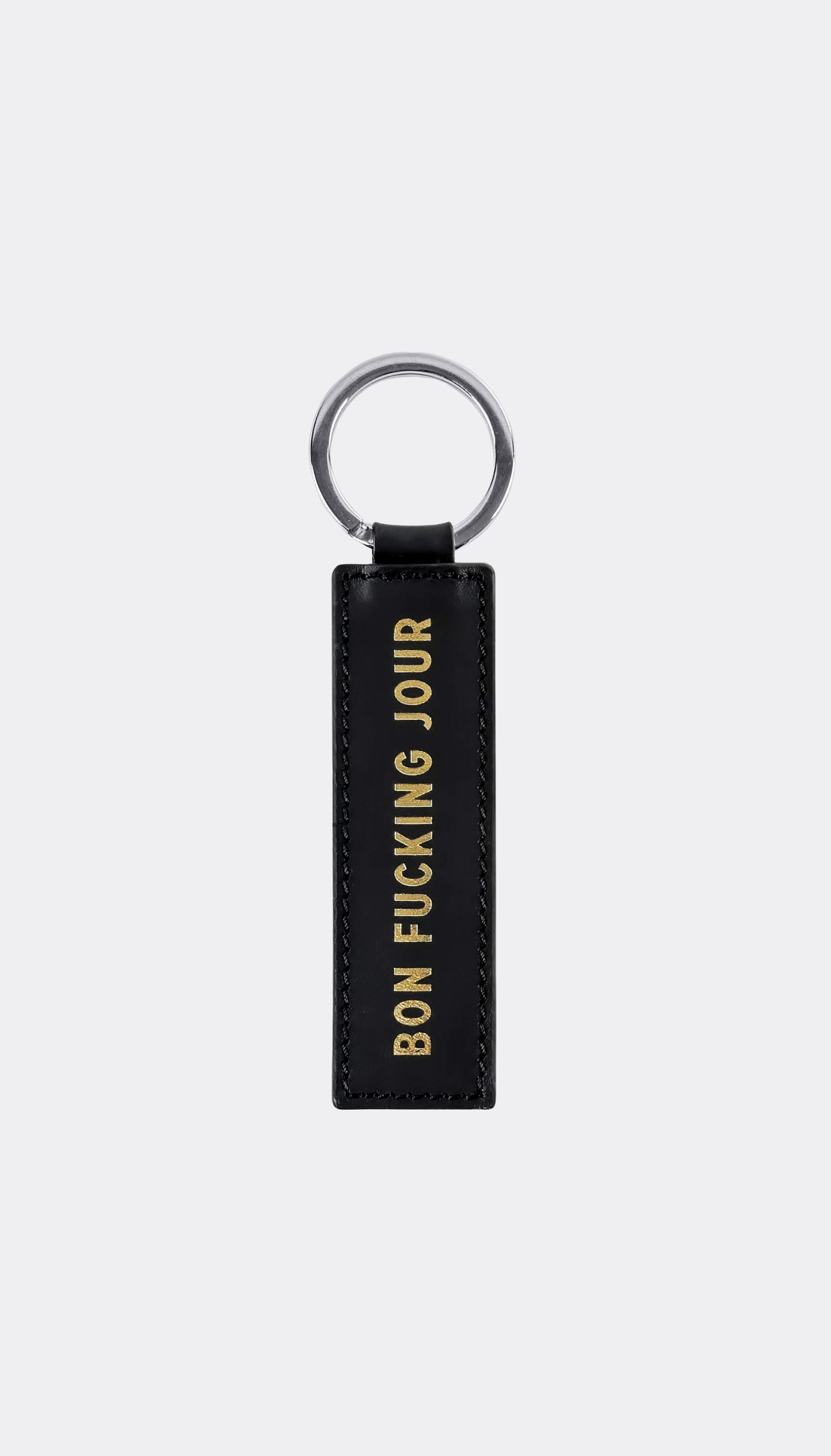 Keychain by SUPERMARQUE with gold engraving saying Bon Fucking Jour