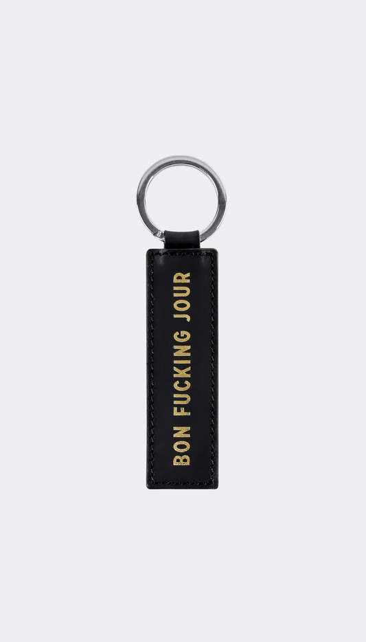 Keychain by SUPERMARQUE with gold engraving saying Bon Fucking Jour